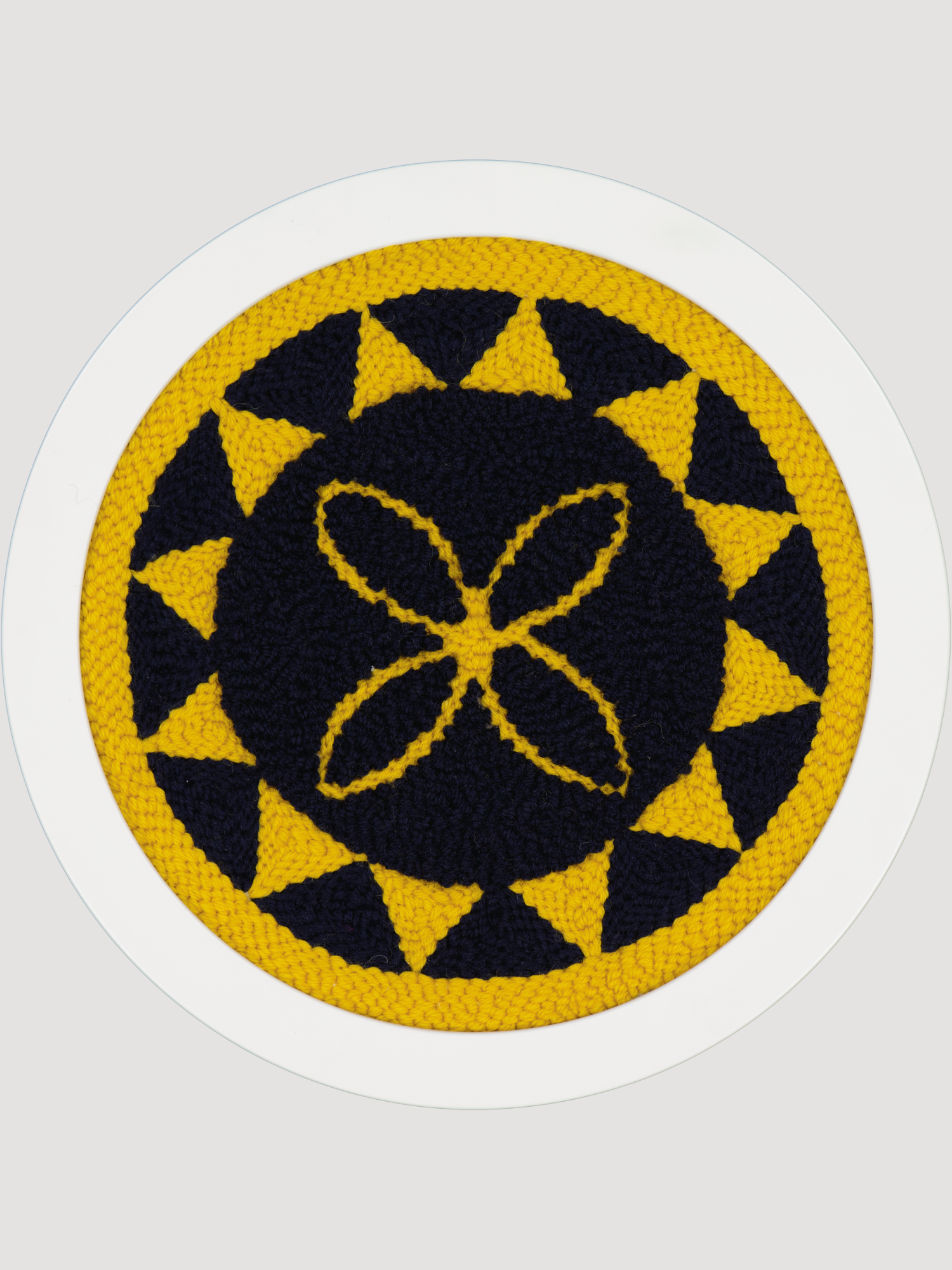 Yellow and navy polynesian round art piece with flower motif