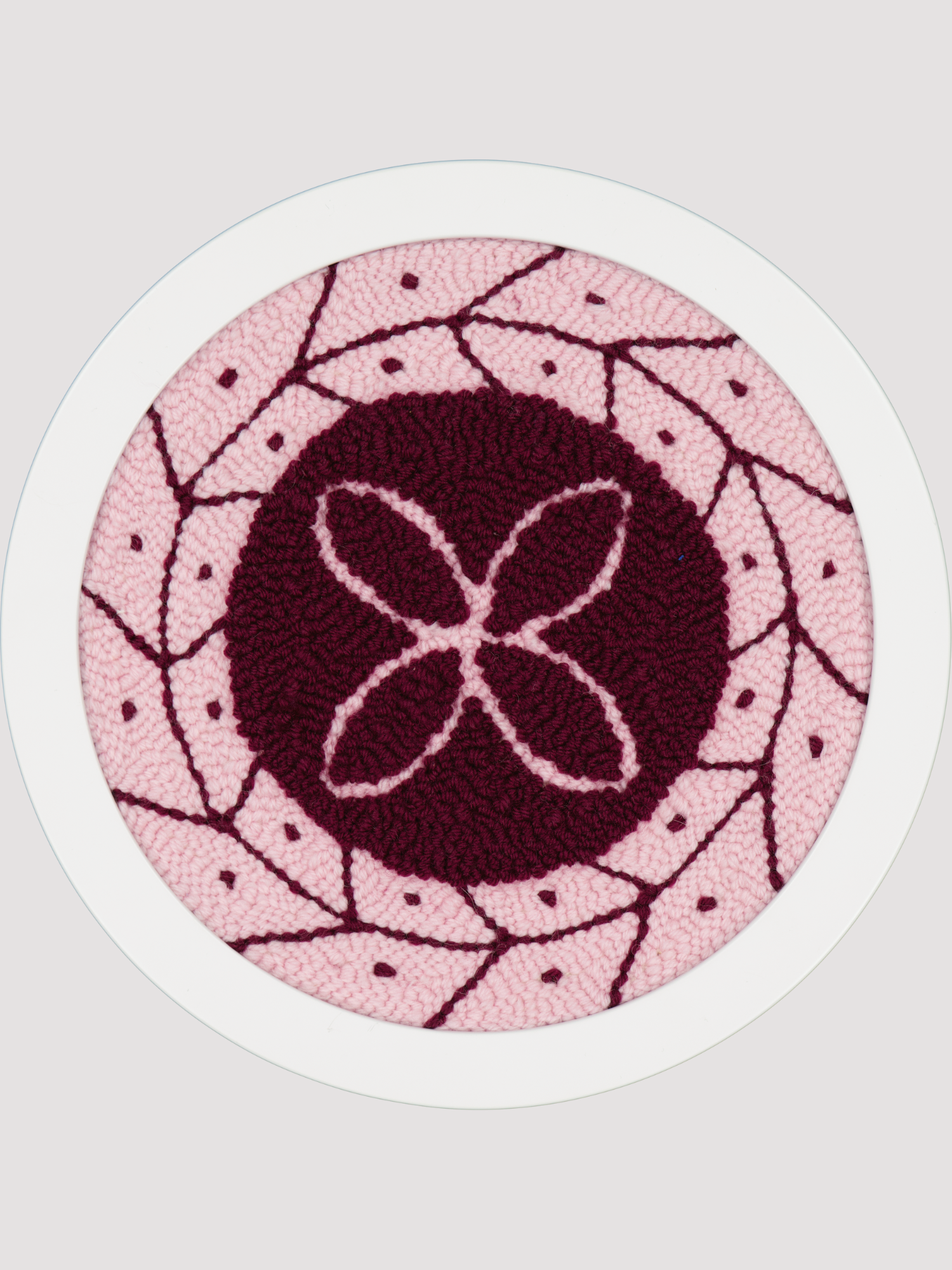 Round pink and red polynesian inspired art piece